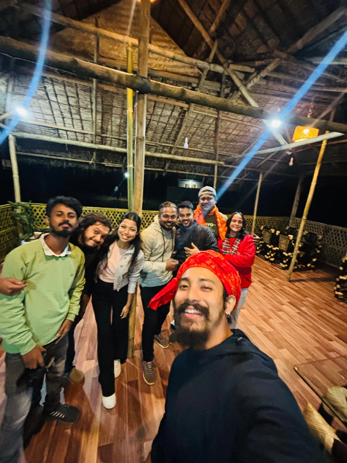 Friends taking a group selfie in the bamboo lounge